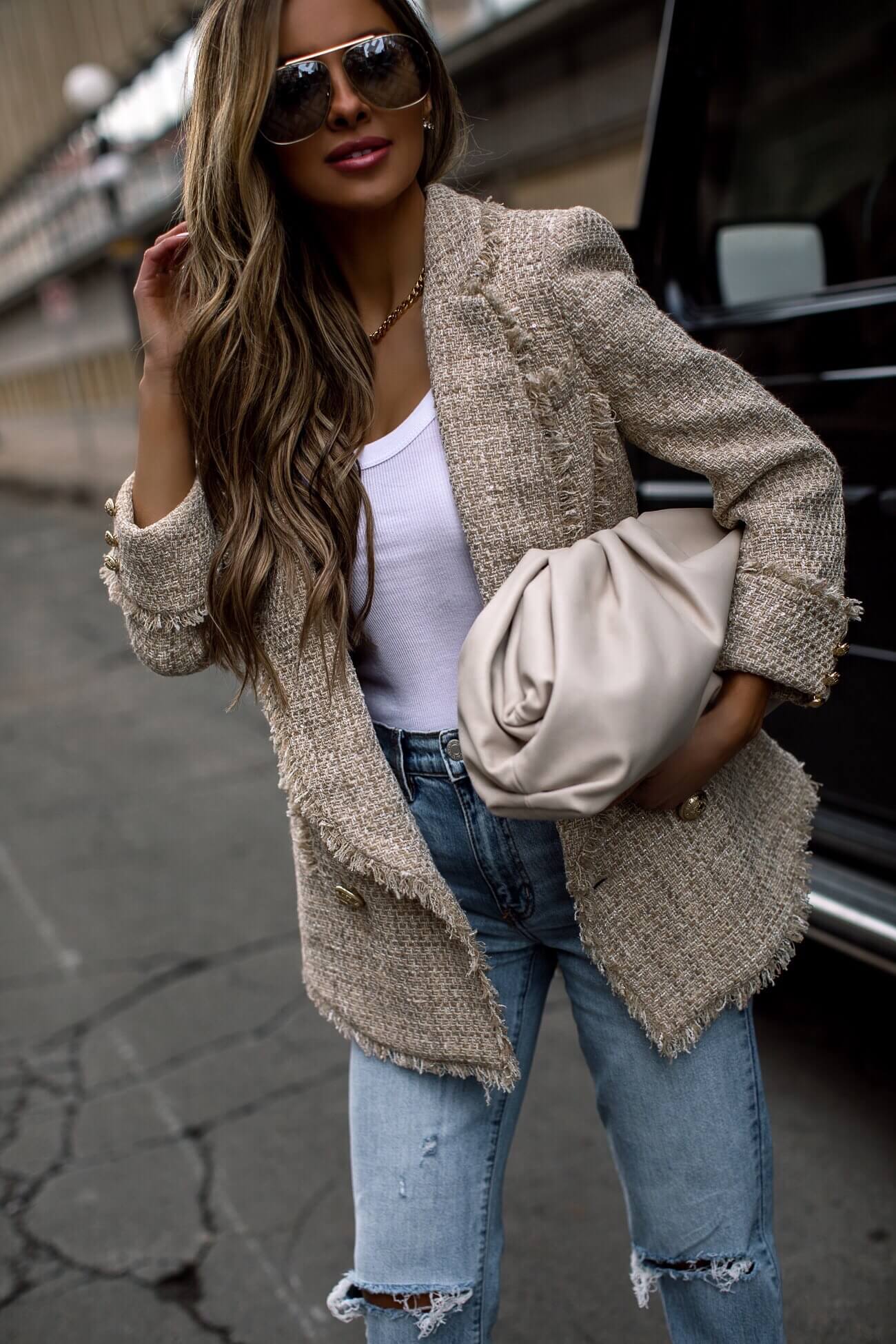 fashion blogger mia mia mine wearing a bottega veneta pouch and a balmain blazer