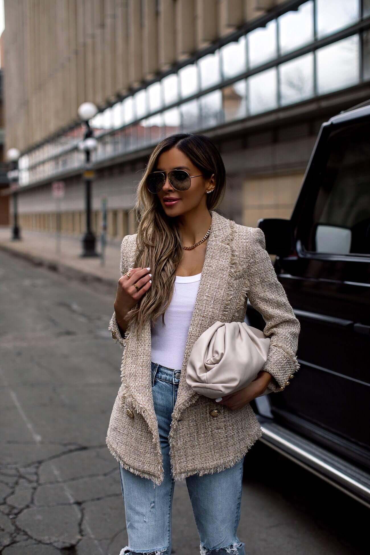 fashion blogger mia mia mine wearing a balmain blazer and bottega bag