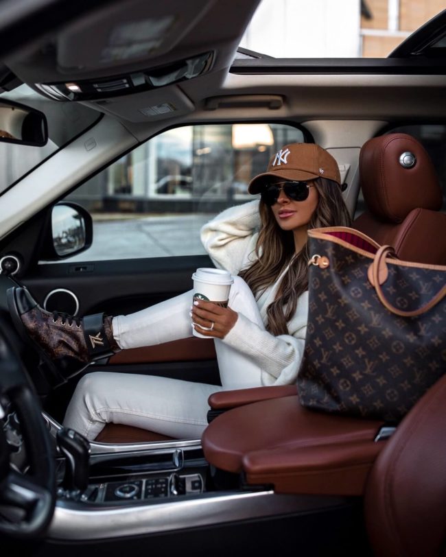 fashion blogger mia mia mine wearing a white outfit from and other stories with louis vuitton combat boots