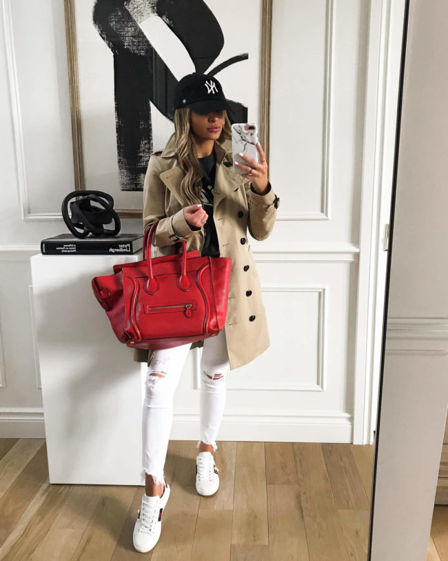 fashion blogger mia mia mine wearing a burberry trench coat and a red celine bag