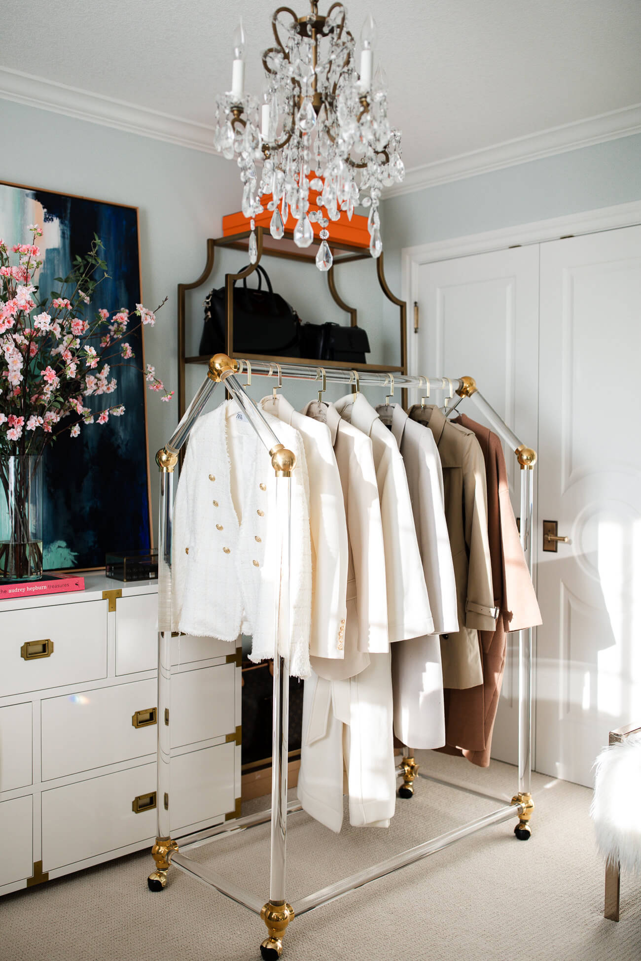 acrylic clothing rack in fashion blogger's closet