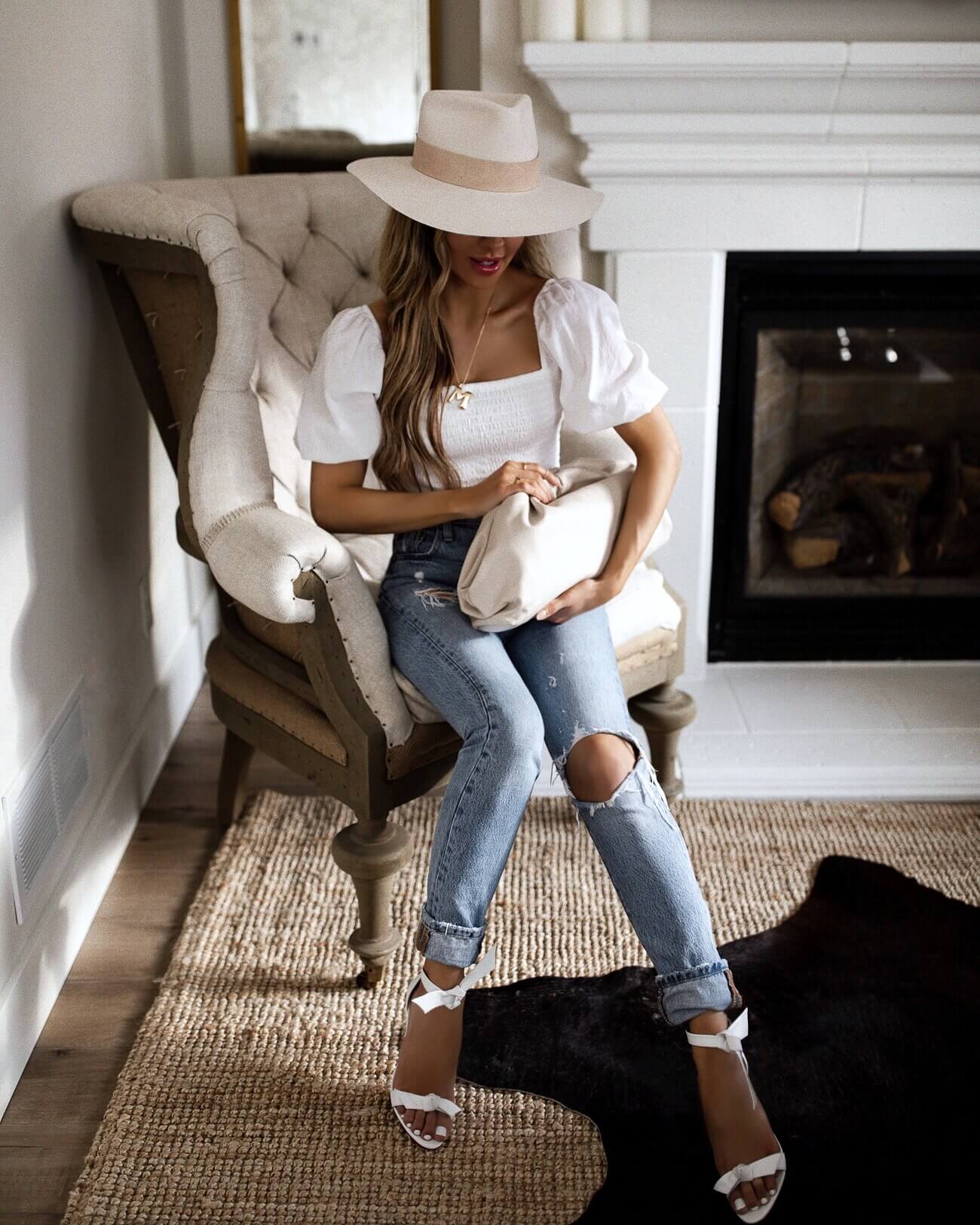 fashion blogger mia mia mine wearing a white linen top and levi's denim