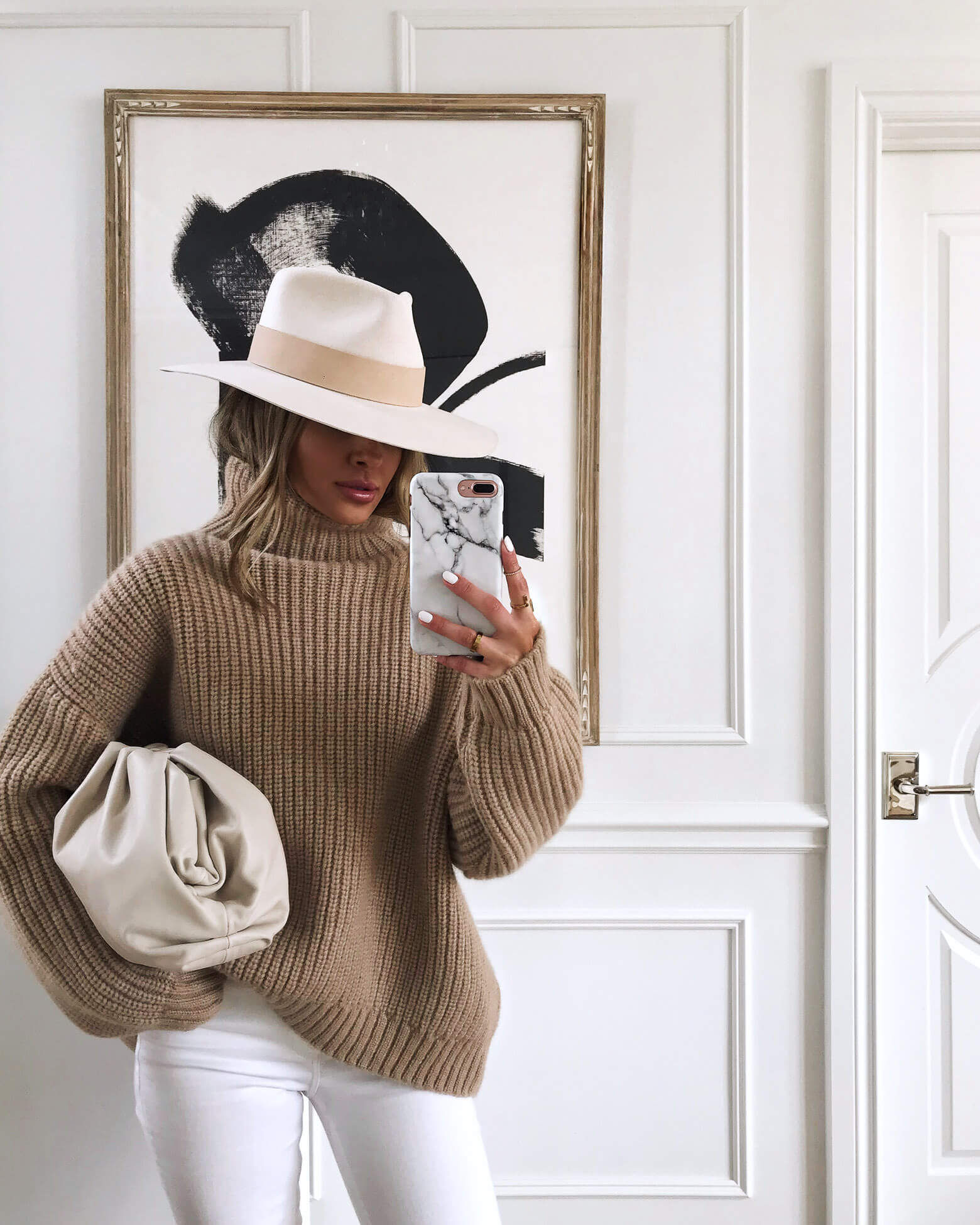 fashion blogger mia mia mine wearing an anine bing sweater and a janessa leone hat