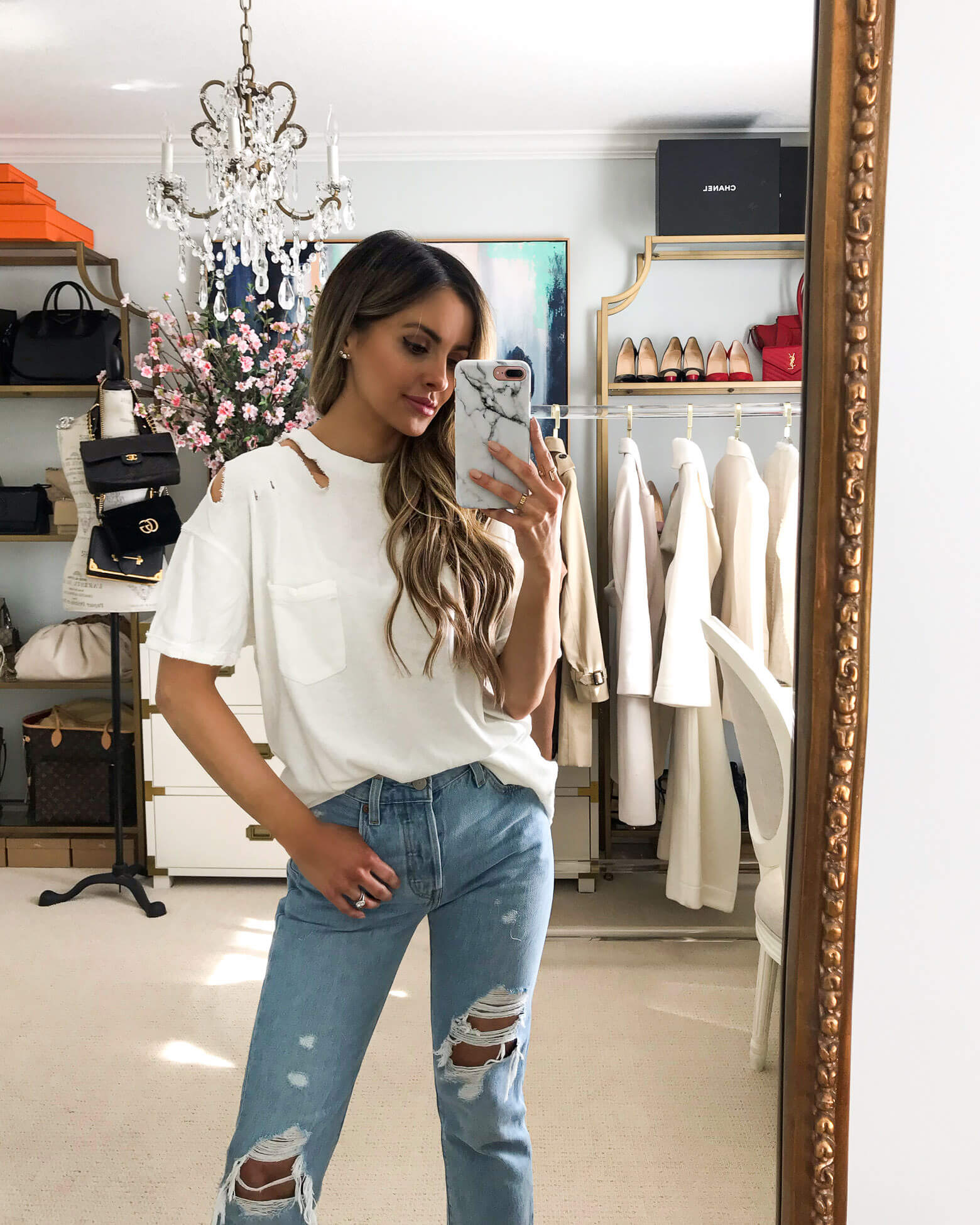 fashion blogger mia mia mine wearing a white free people top and levi's denim