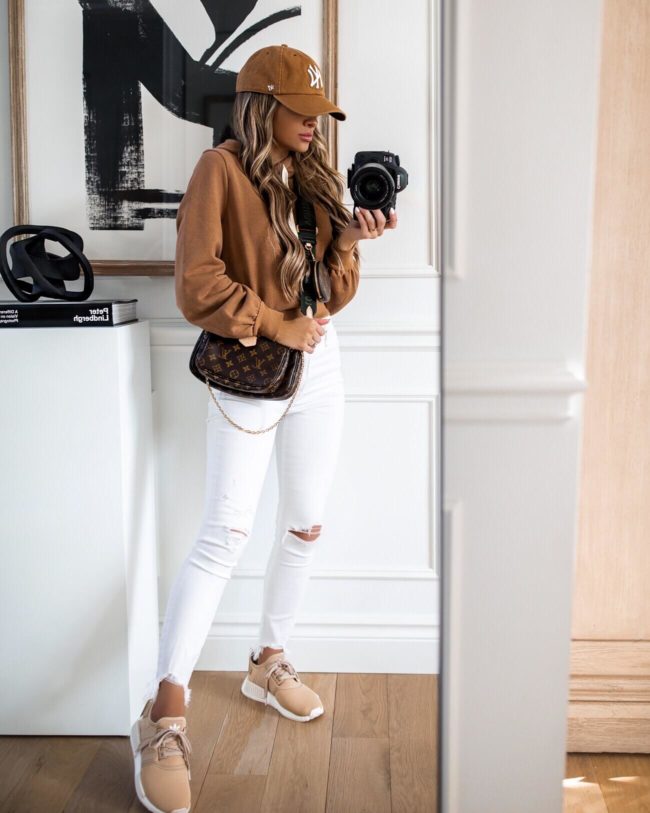 fashion blogger mia mia mine wearing a camel sweatshirt and adidas sneakers