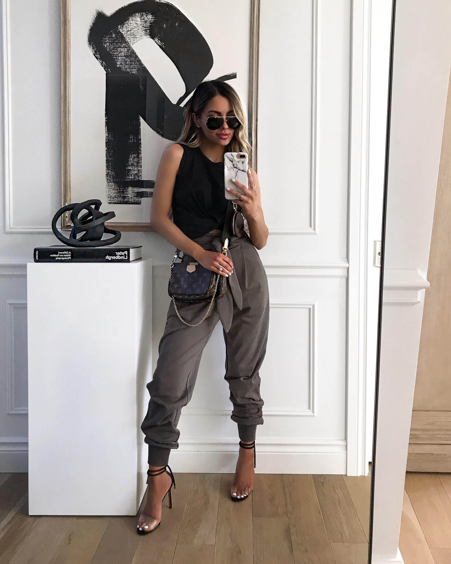 fashion blogger mia mia mine wearing jogger pants from revolve and a louis vuitton mulit pochette accessories bag