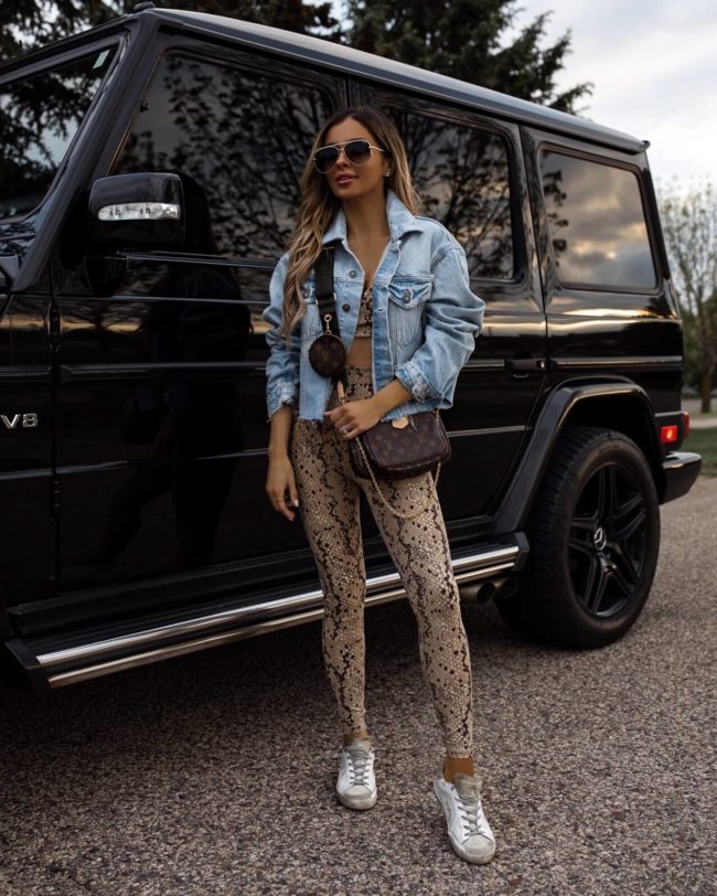 fashion blogger mia mia mine wearing a snakeskin outfit from revolve with the louis vuitton multi pochette accessoires