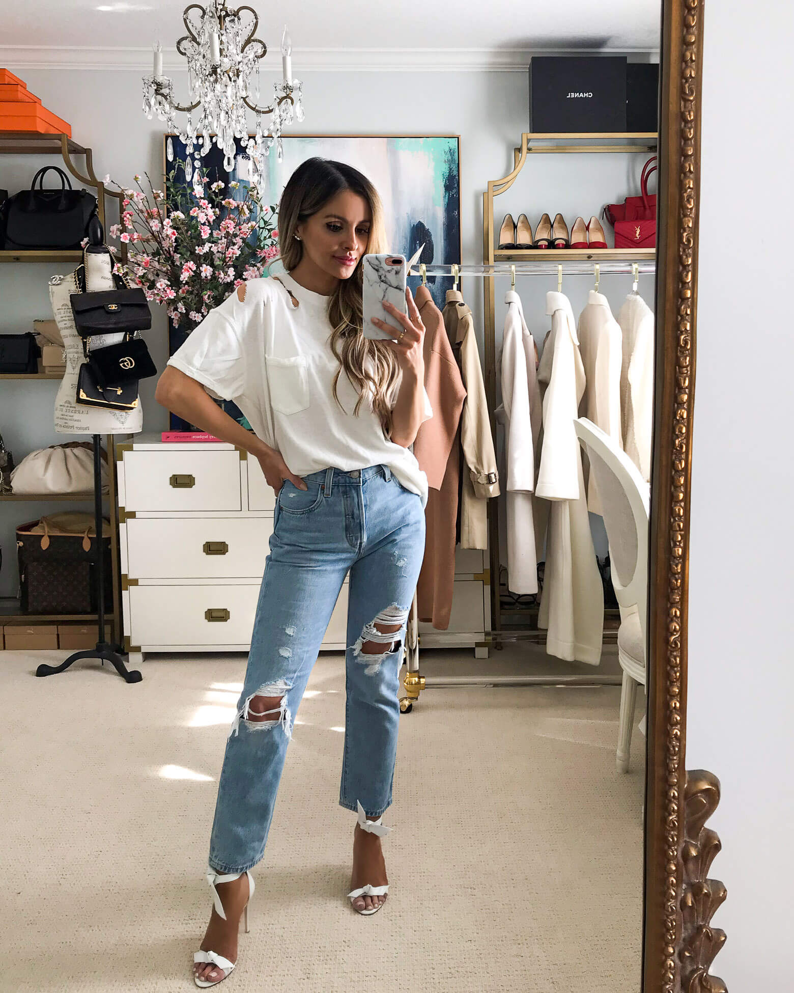 fashion blogger mia mia mine wearing a white distressed top by free people and levi's denim