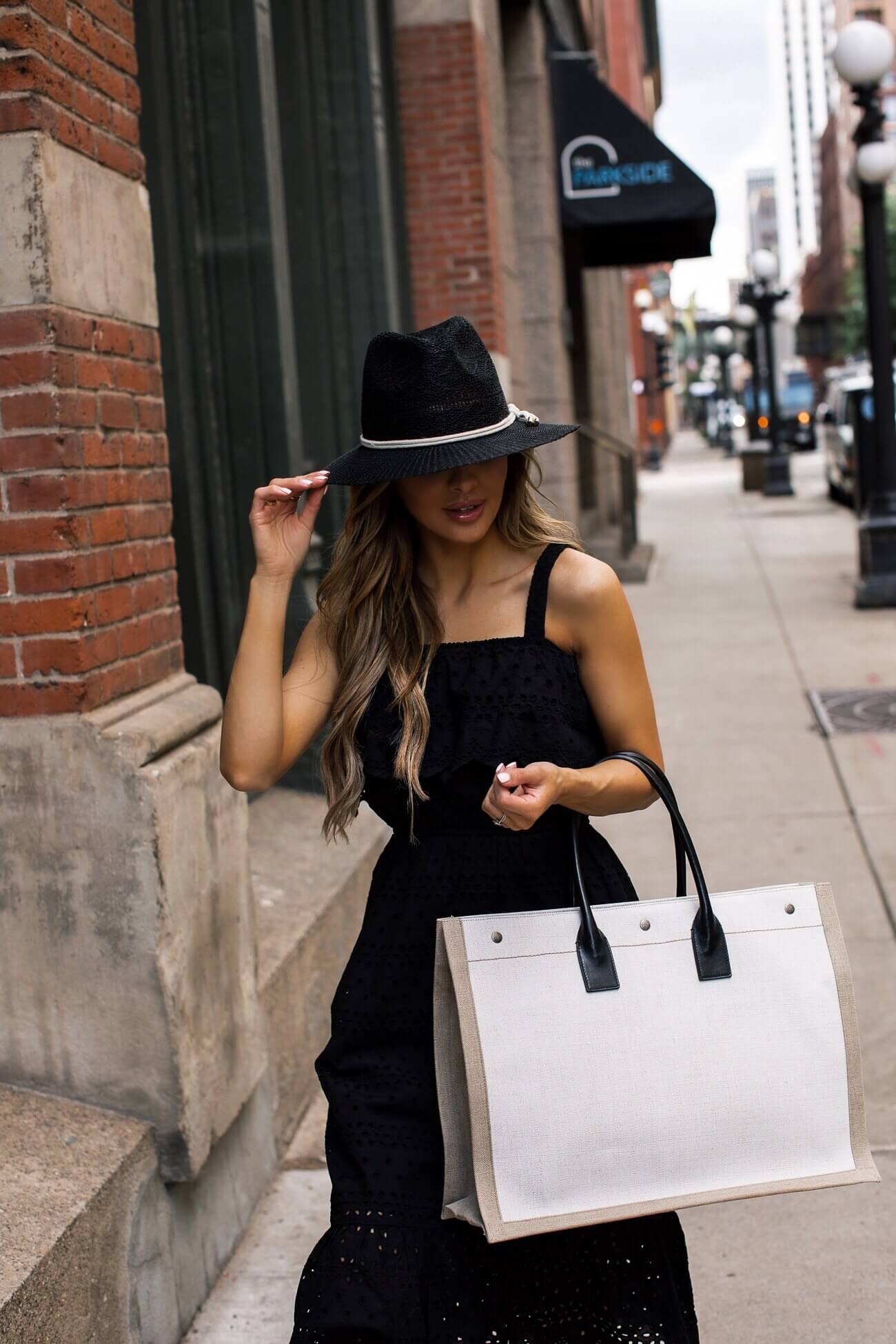 fashion blogger mia mia mine wearing a black dress and black hat from walmart