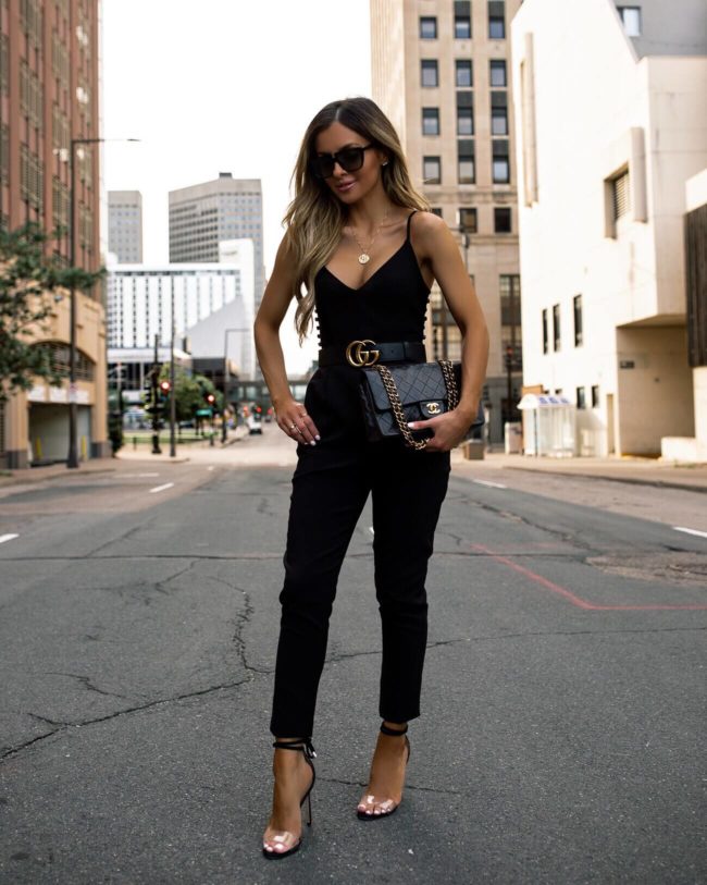 fashion blogger mia mia mine wearing a black jumpsuit and gucci belt for summer
