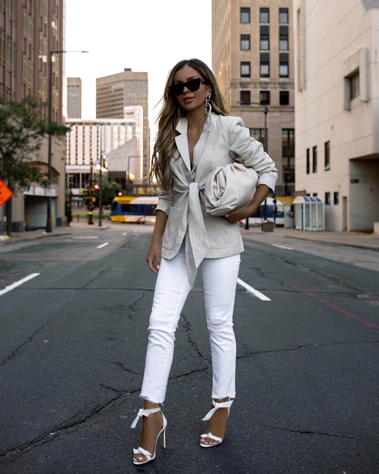 fashion blogger mia mia mine wearing a linen blazer and white denim