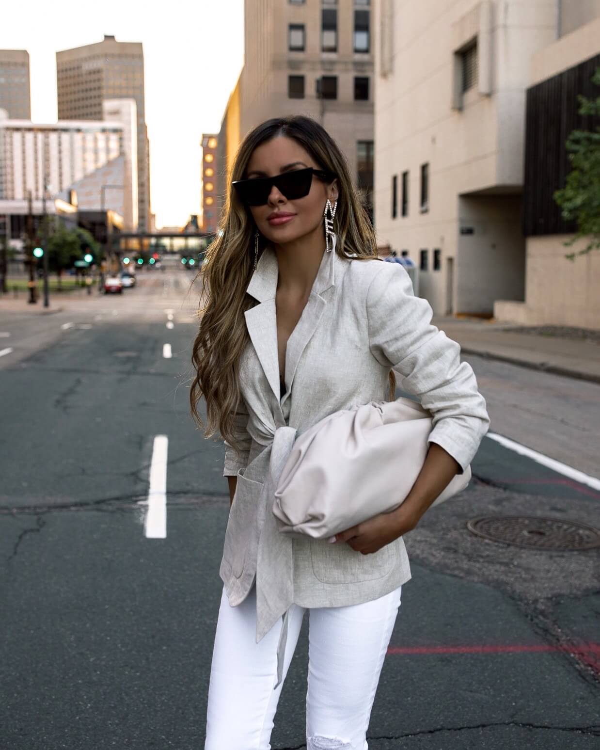 fashion blogger mia mia mine wearing a linen blazer and a white bottega veneta bag