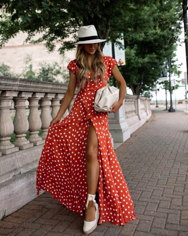 fashion blogger mia mia mine wearing a polka dot maxi dress from revolve and a white panama hat for summer