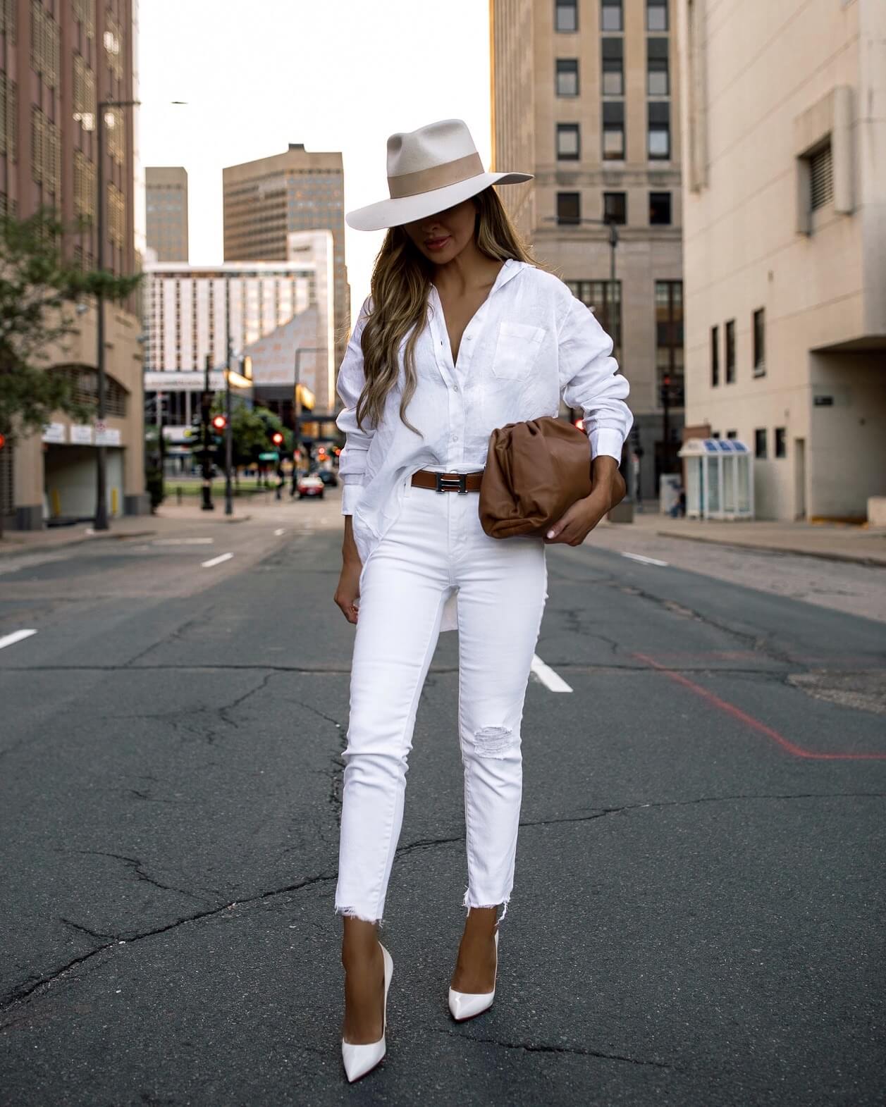fashion blogger mia mia mine wearing a white linen shirt and white denim