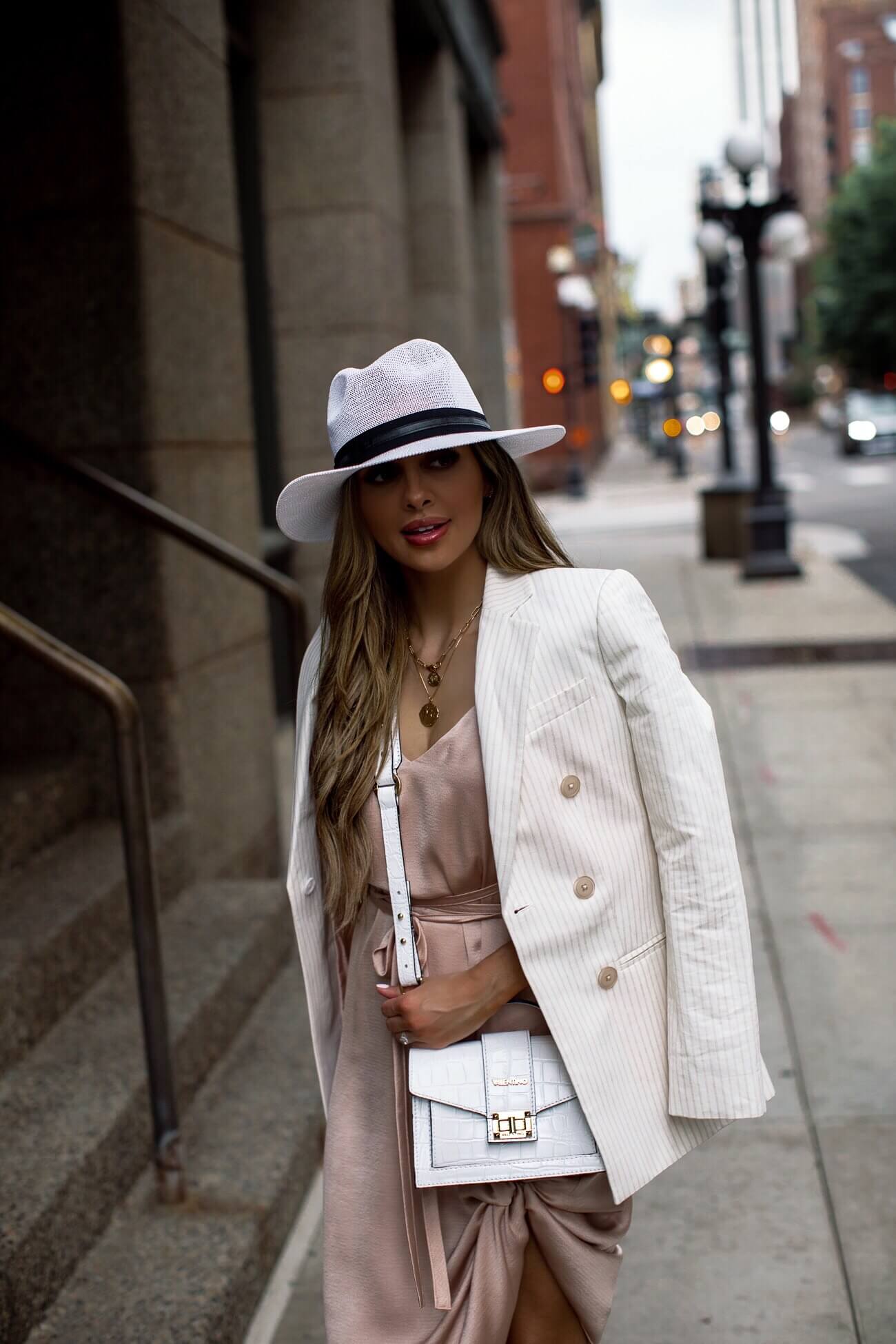 mia mia mine wearing a pink silk dress and white hat for summer