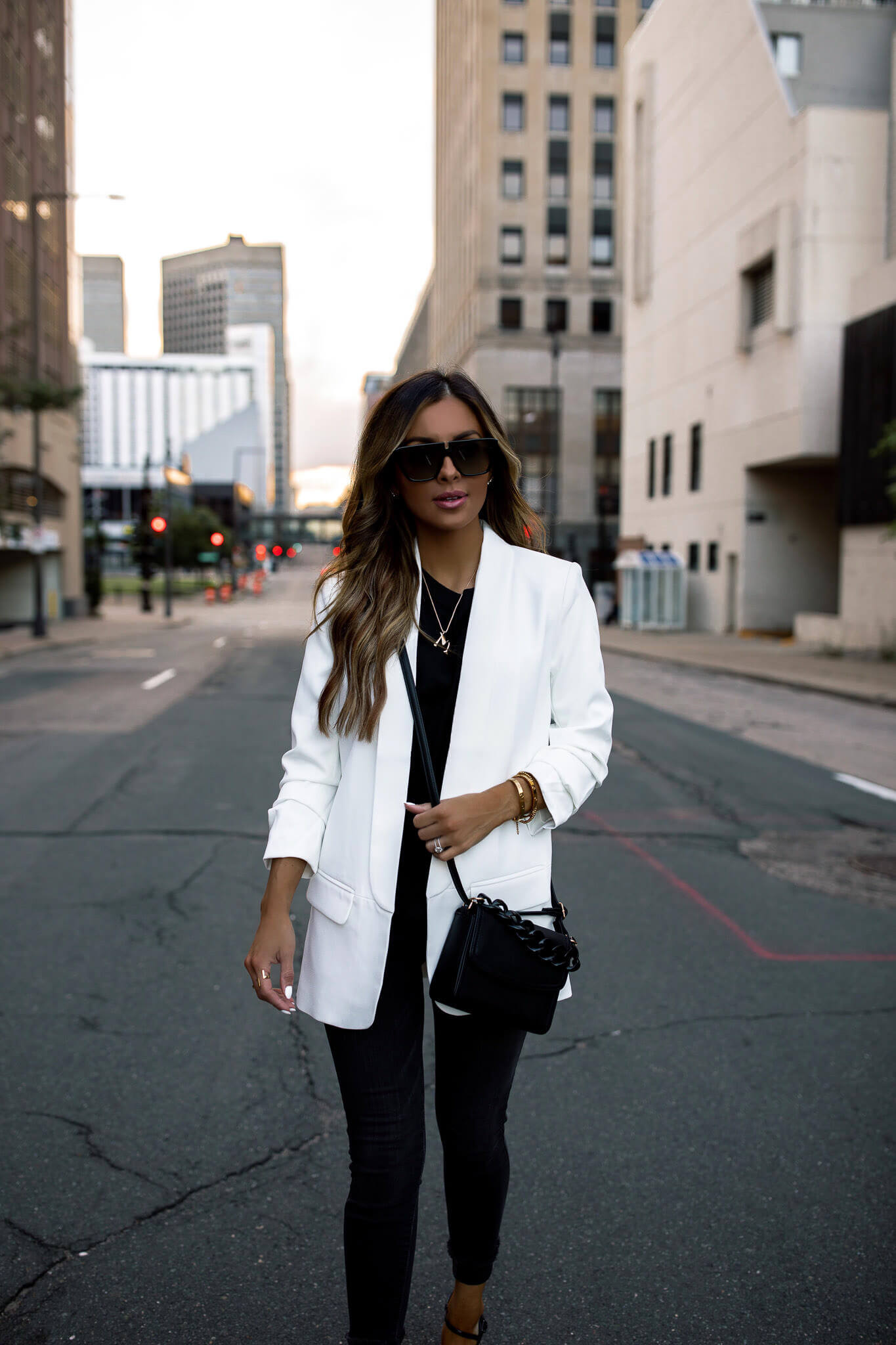 fashion blogger mia mia mine wearing a white blazer from walmart and a black bag