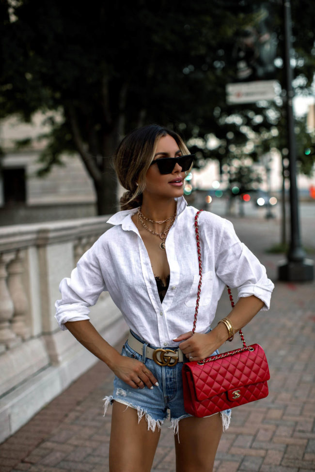 fashion blogger mia mia mine wearing a red chanel bag and a gucci belt