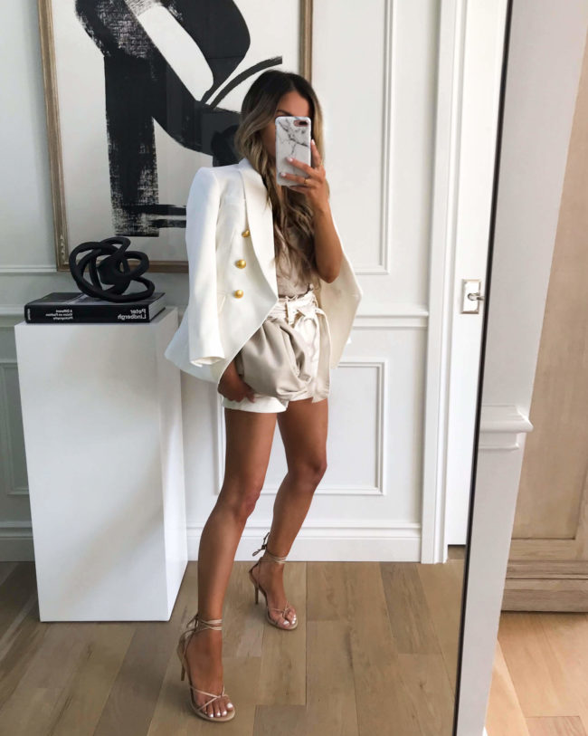 fashion blogger mia mia mine wearing a white blazer and express heels for summer