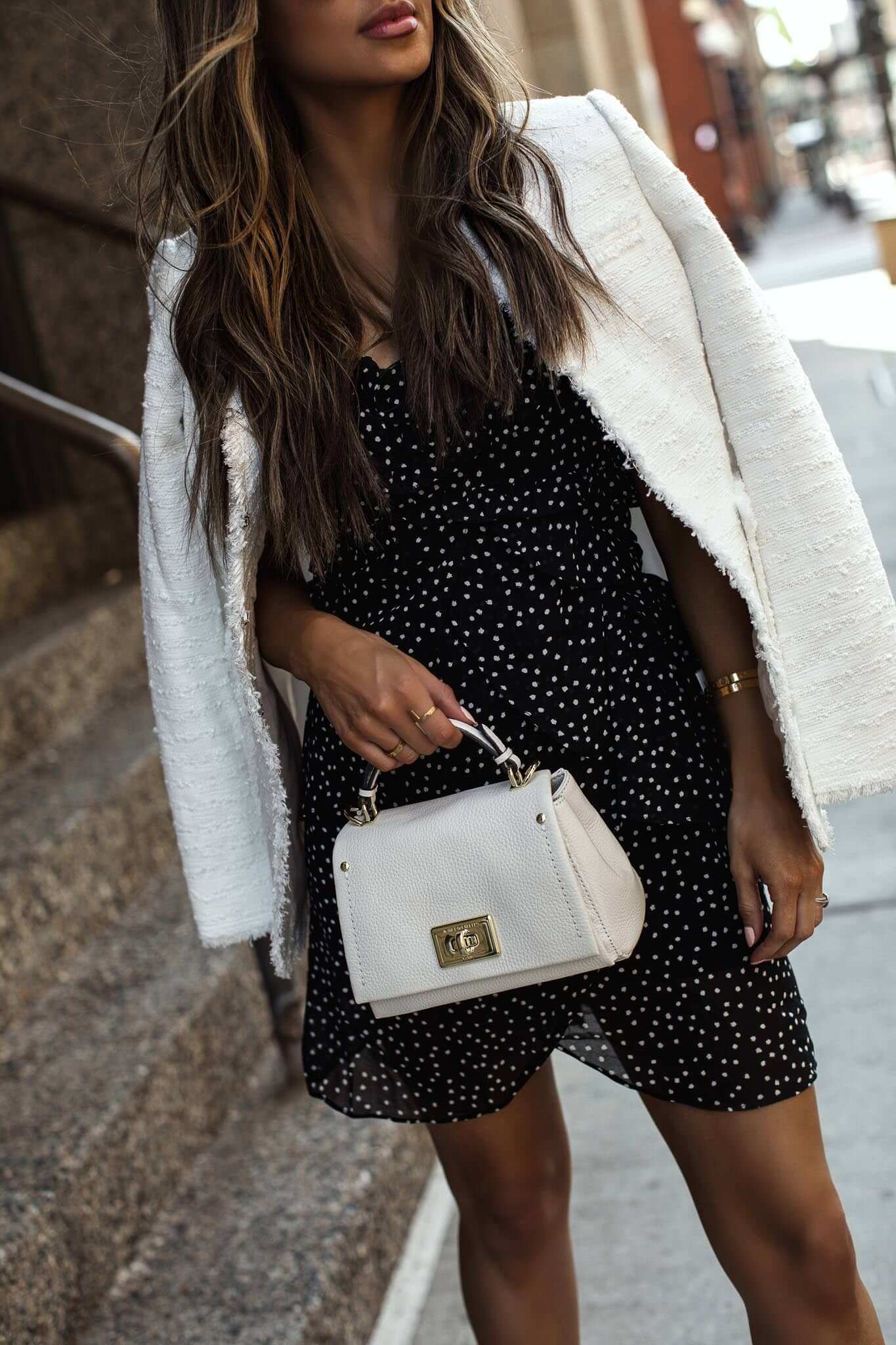 fashion blogger mia mia mine wearing a black and white dress from saks off 5th