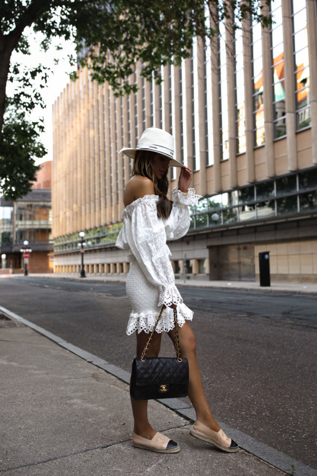 fashion blogger mia mia mine wearing a white eyelet dress from revolve