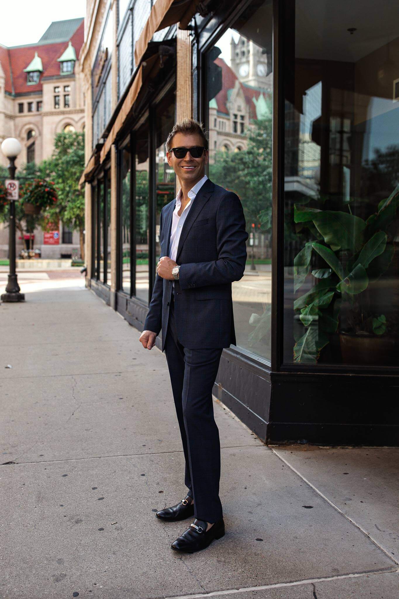 men's fashion blogger wearing a hugo boss suit and ferragmo belt