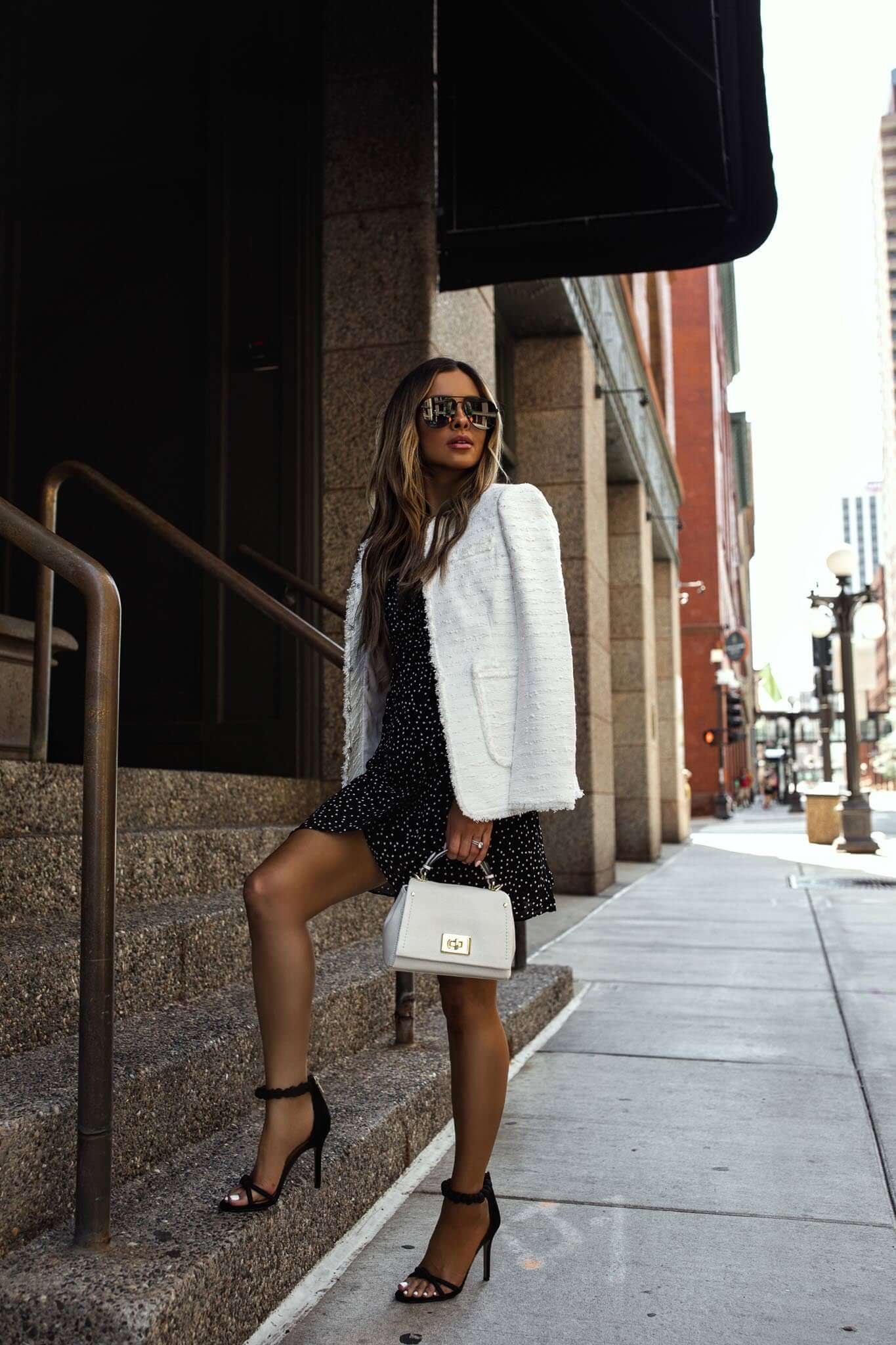 fashion blogger mia mia mine wearing a white blazer and black and white dress from saks off 5th