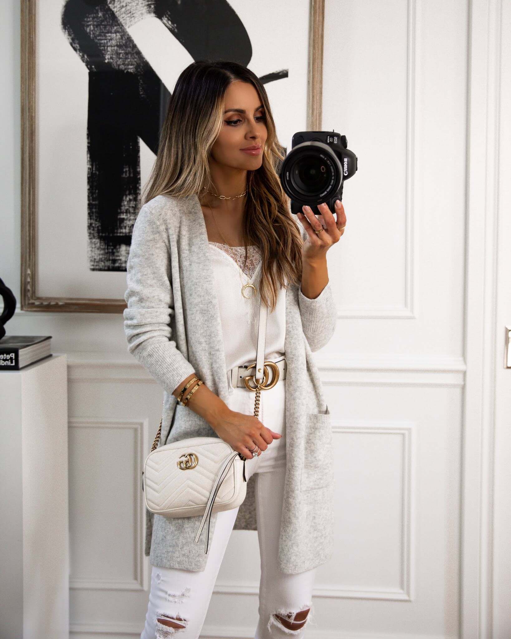 fashion blogger wearing a madewell cardigan from the nsale with a white gucci bag