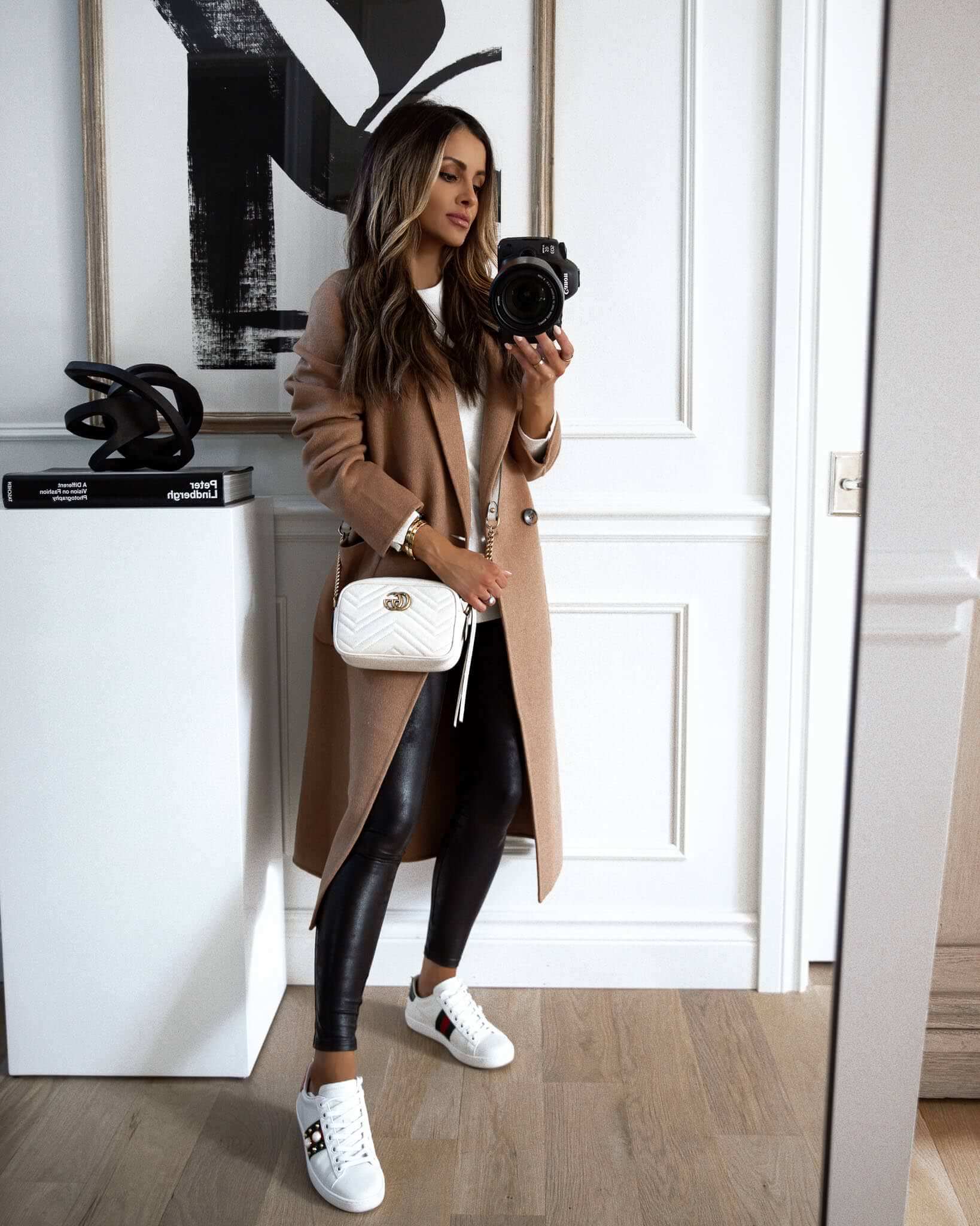 mia mia mine wearing a camel coat and spanx leather leggings from the nsale 2020
