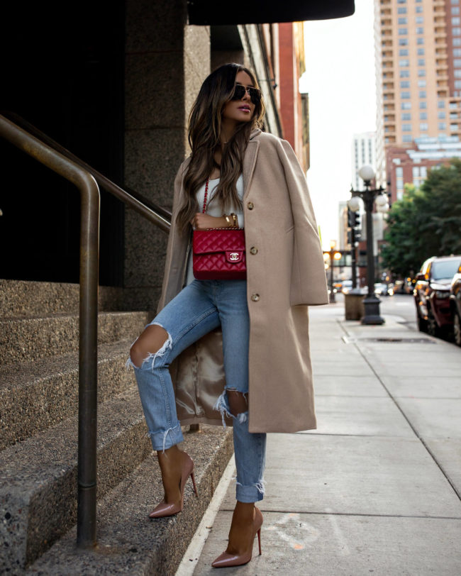 fashion blogger mia mia mine wearing a camel coat from abercrombie with a red chanel bag