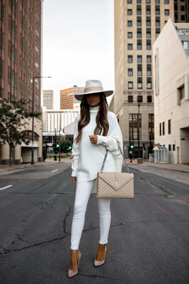 fashion blogger mia mia mine wearing a white tunic sweater from amazon