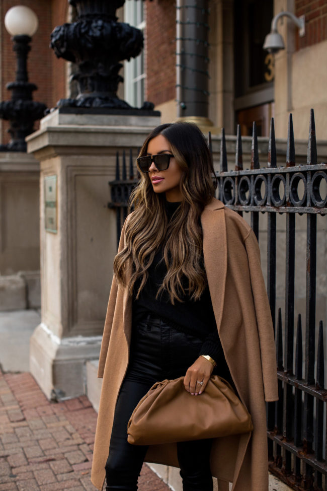 fashion blogger mia mia mine wearing a camel coat from express