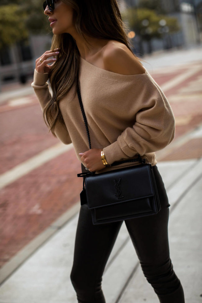 fashion blogger mia mia mine wearing a camel sweater and black leather pants from intermix