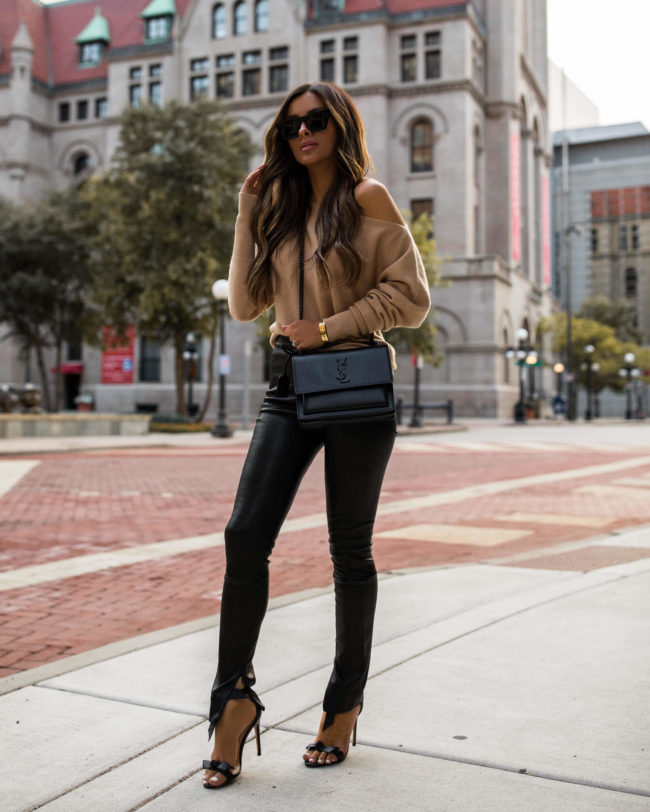 mia mia mine wearing a camel sweater and leather pants from intermix fall 2020