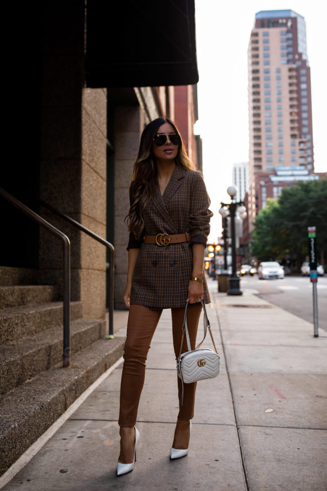 fashion blogger wearing a plaid blazer and a white gucci bag