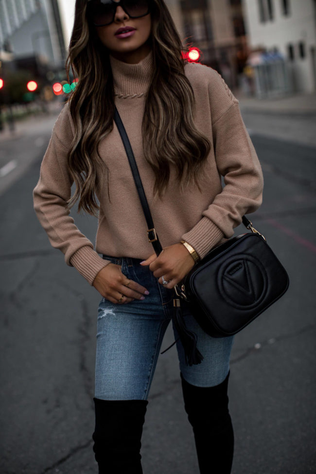 fashion blogger mia mia mine wearing a camel sweater and a valentino bag from saks off 5th