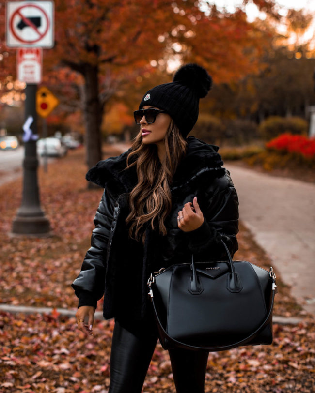 fashion blogger mia mia mine wearing a black puffer jacket from express
