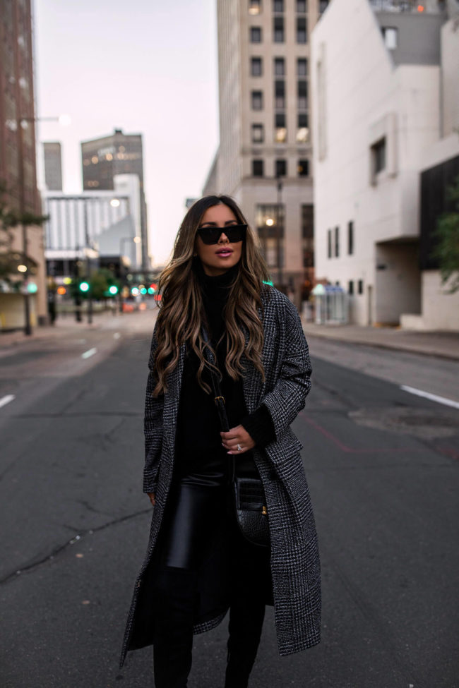 fashion blogger mia mia mine wearing a black crossbody bag and faux leather leggings from walmart