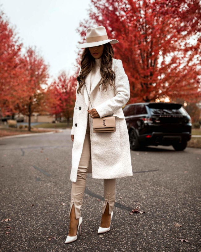 fashion blogger mia mia mine wearing a white coat from express for fall