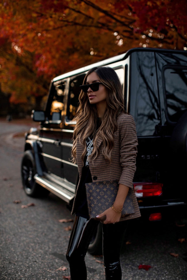 fashion blogger mia mia mine wearing a plaid blazer from express and a louis vuitton toiletry pouch 26