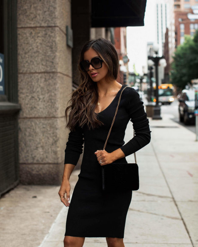 fashion blogger wearing a black dress by sofia jeans
