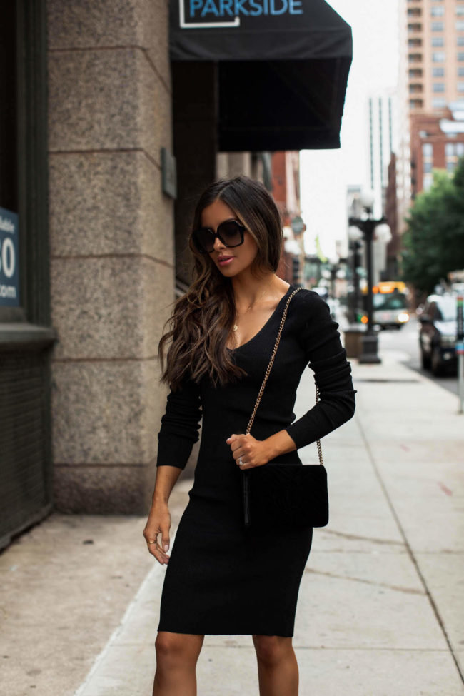 fashion blogger wearing a black dress by sofia jeans