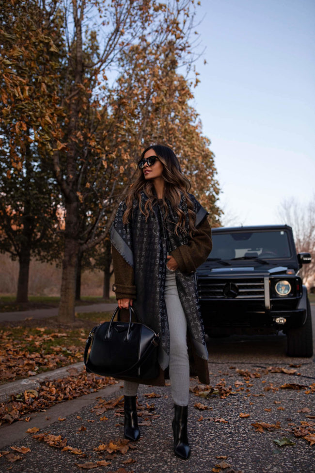 fashion blogger wearing a black louis vuitton shine shawl