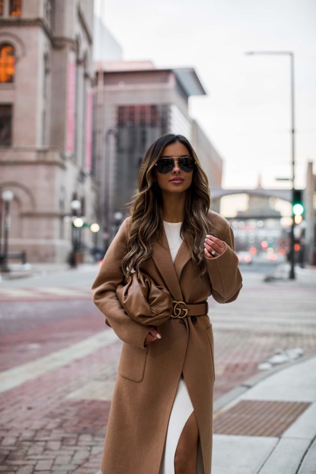 mia mia mine wearing a camel coat and gucci belt from cettire