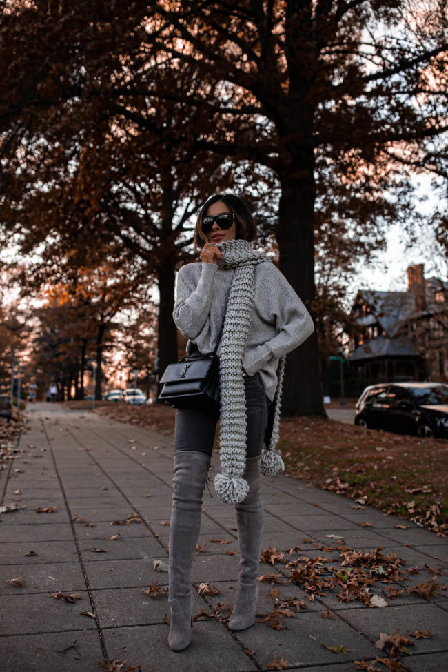 fashion blogger mia mia mine wearing a chunky knit scarf from express