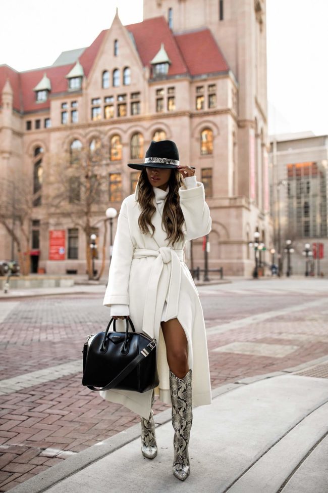 fashion blogger mia mia mine wearing a white coat and snakeskin boots for winter