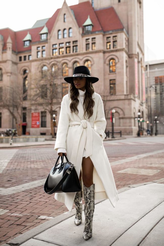 fashion blogger mia mia mine wearing a white coat and snakeskin boots with a givenchy bag