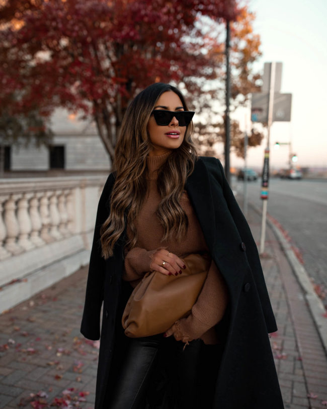 fashion blogger wearing a camel bottega veneta pouch