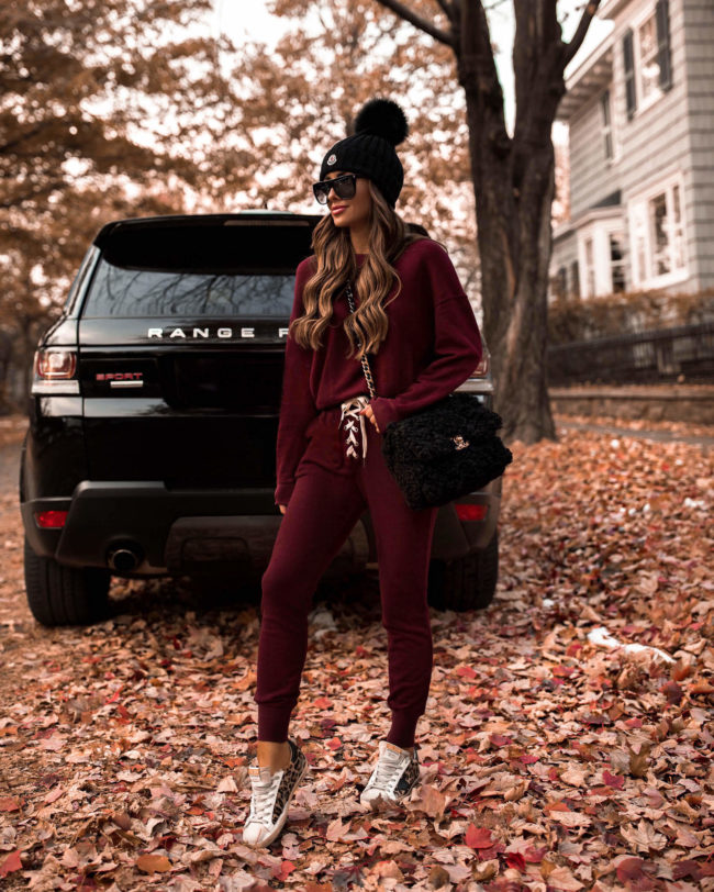 fashion blogger mia mia mine wearing a red sweatsuit from revolve