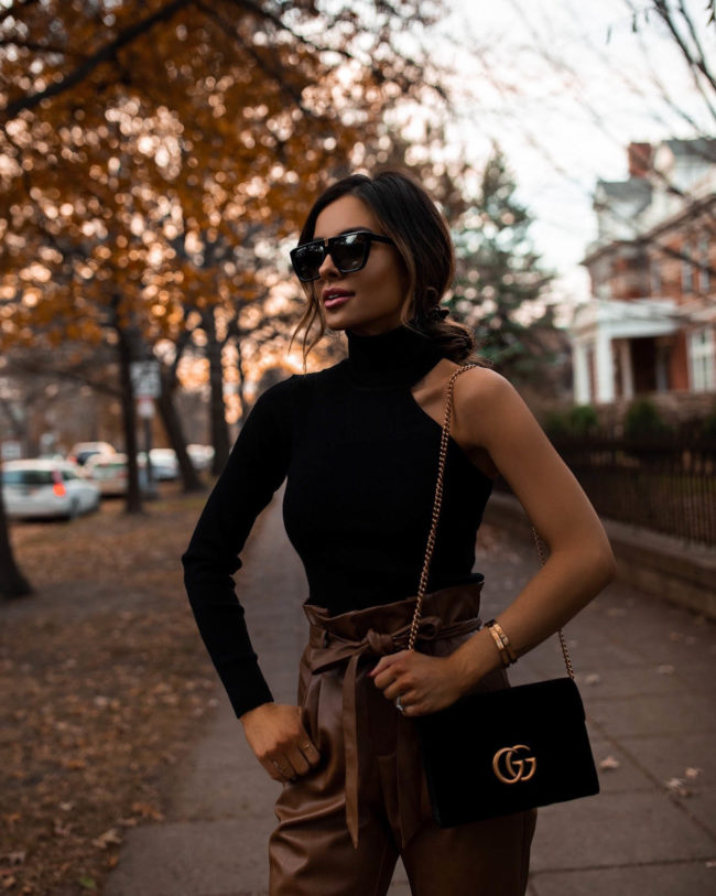 fashion blogger mia mia mine wearing a one shoulder sweater from bloomingdales