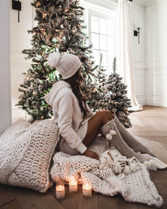 mia mia mine wearing a faux sherpa pullover and pom pom beanie with knee high socks from nordstrom